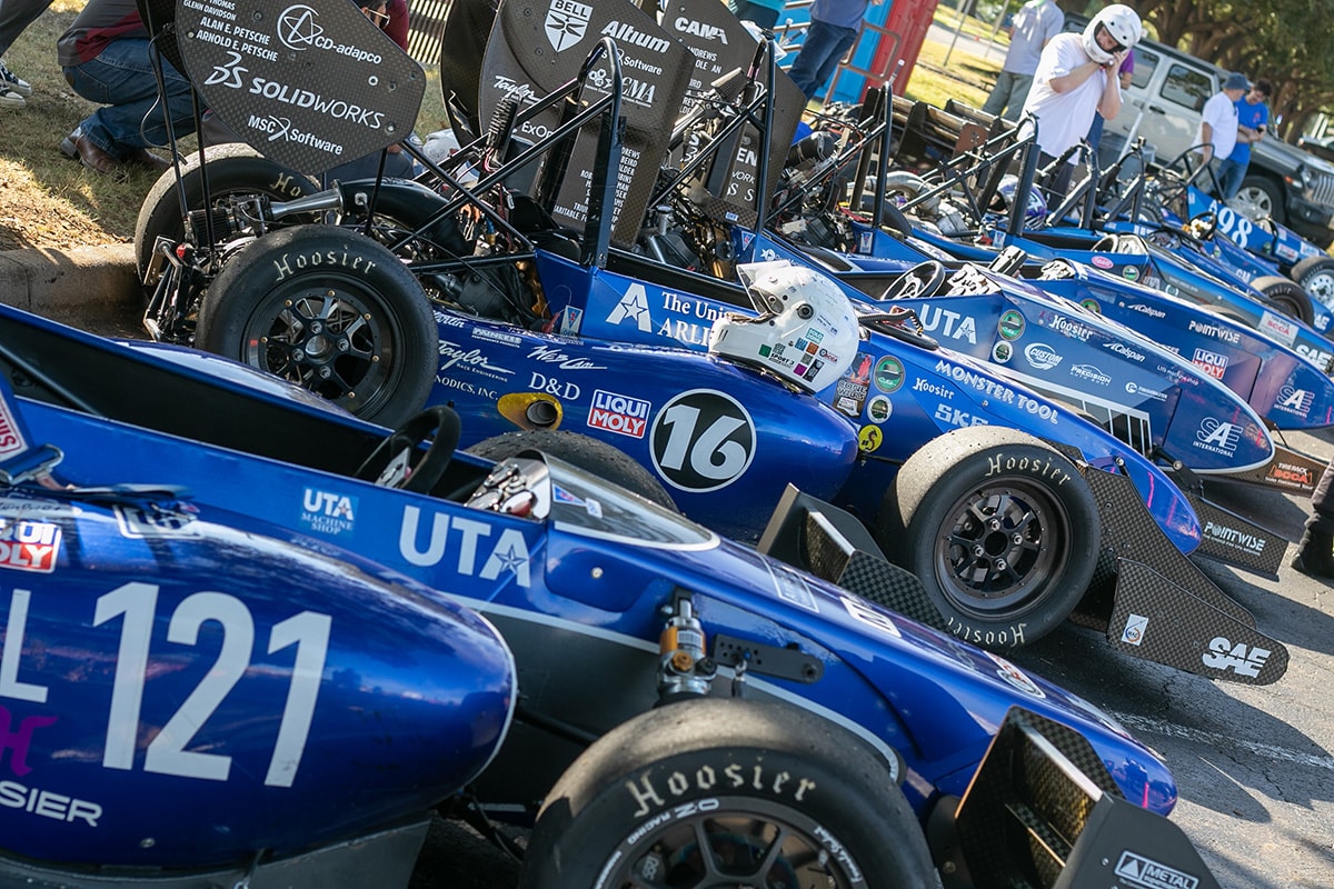 Row of parked UTA racecars - opens in a new tab