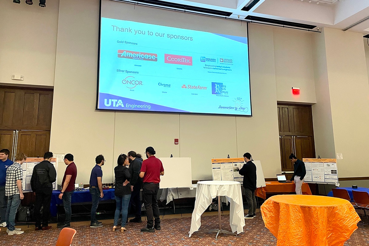 People looking at a various projects in a large room at a UTA event - opens in a new tab