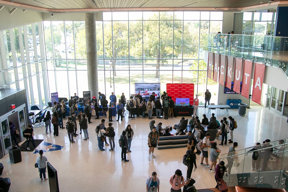 Students mingling at Hack UTA event - opens in a new tab
