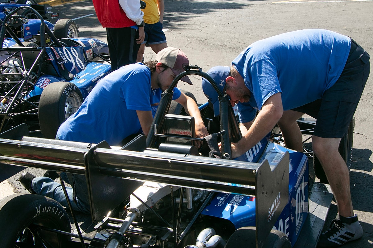 Man sitting in a UTA racecar - opens in a new tab