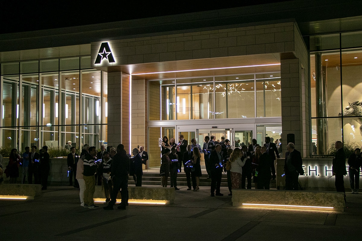 Banquet invitees gathering in front of a UTA building - opens in a new tab